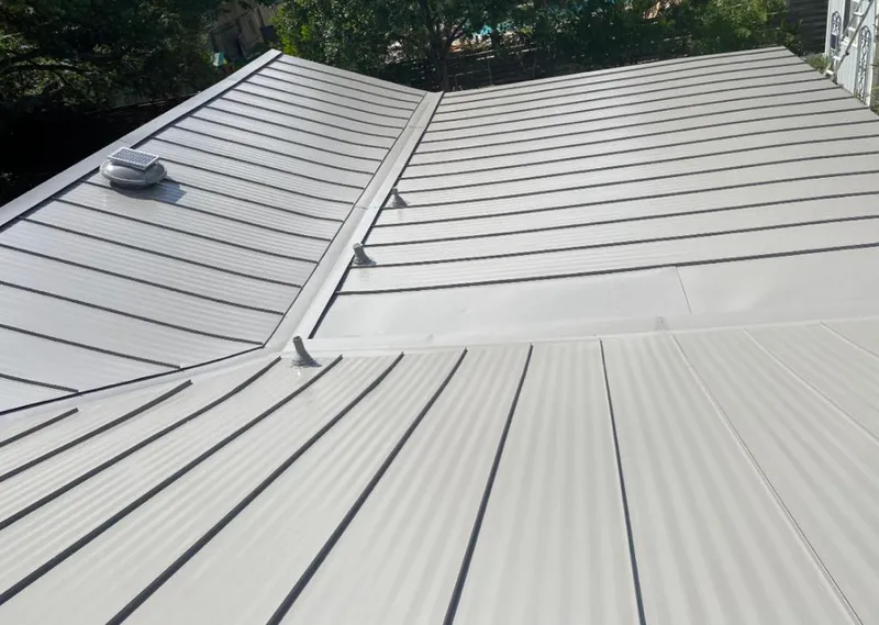 Solar attic fan installed on a metal roof for Roof Ventilation in Glassmanor